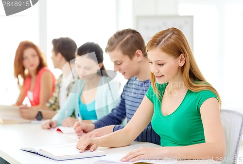 Image of students with textbooks and books at school