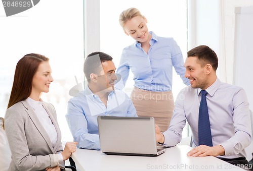 Image of business team working with laptop in office