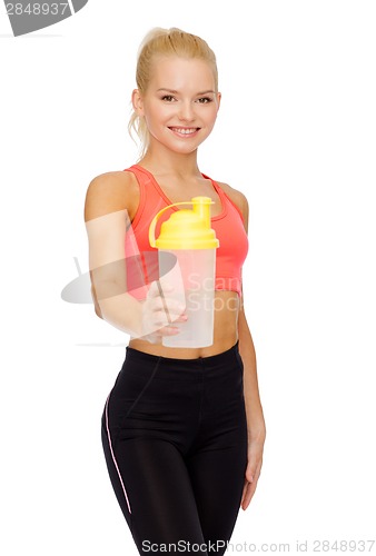 Image of smiling sporty woman with protein shake bottle