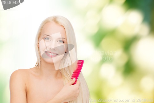 Image of smiling woman with hair brush