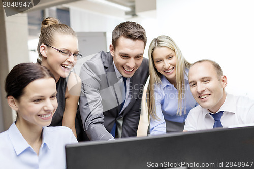 Image of business team with monitor having discussion