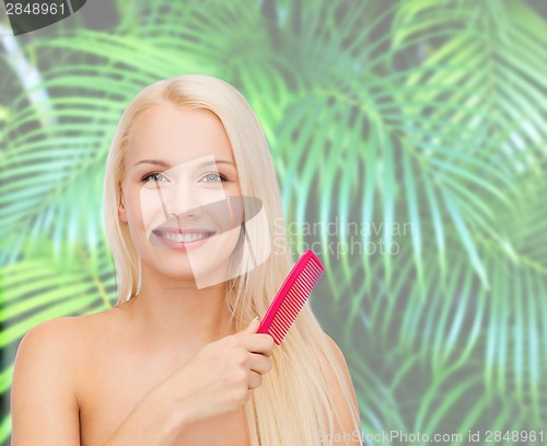 Image of smiling woman with hair brush