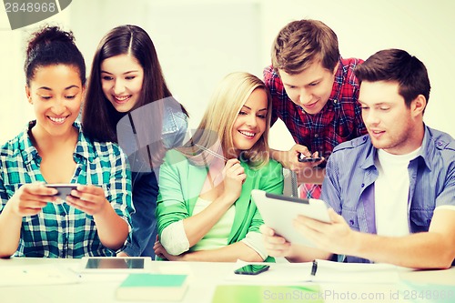 Image of students looking at smartphones and tablet pc