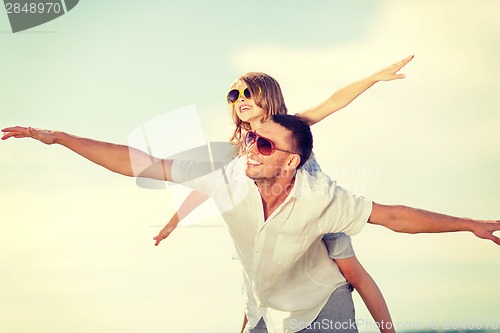 Image of happy father and child in sunglasses over blue sky