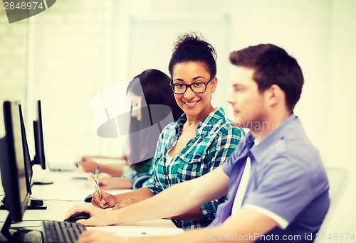 Image of african student with computer studying at school