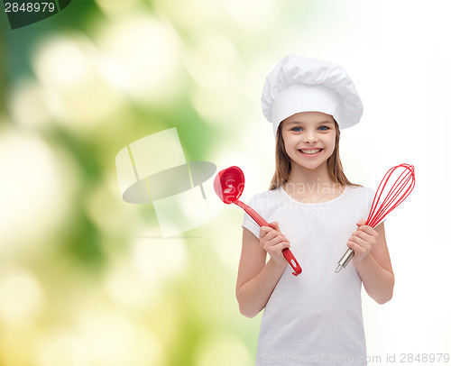 Image of smiling girl in cook hat with ladle and whisk