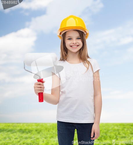 Image of smiling little girl in helmet with paint roller