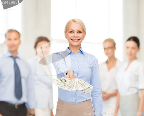 Image of young businesswoman with dollar cash money