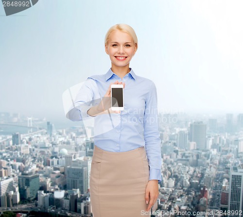 Image of smiling businesswoman with smartphone blank screen