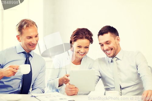 Image of business team having fun with tablet pc in office