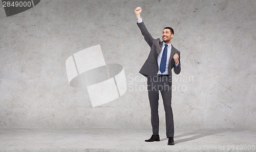 Image of happy businessman with hands up