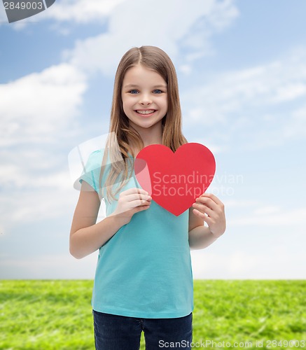 Image of smiling little girl with red heart