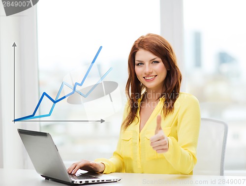 Image of smiling student with laptop computer at school