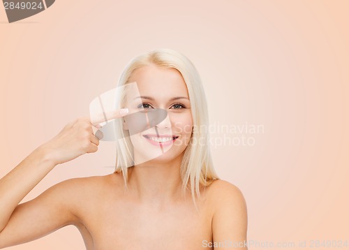 Image of beautiful woman touching her eye area