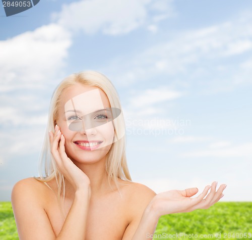 Image of smiling woman holding imaginary lotion jar