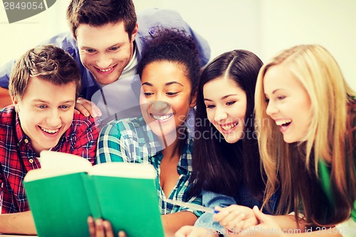 Image of students reading book at school