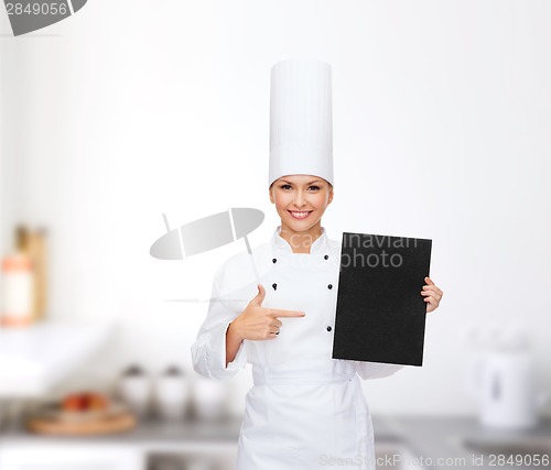 Image of smiling female chef with black blank paper