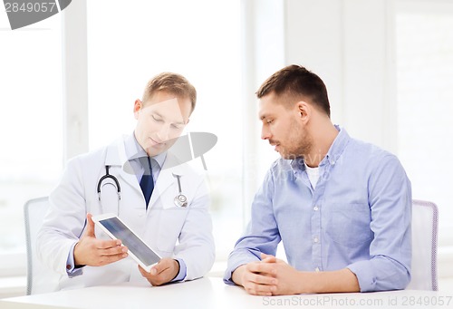 Image of doctor with tablet pc and patient in hospital