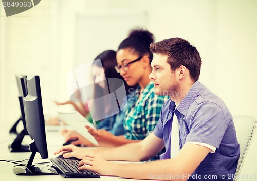 Image of students with computers studying at school