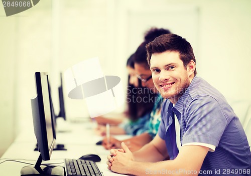 Image of student with computer studying at school