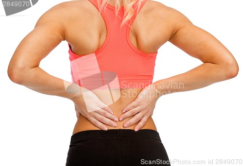 Image of close up of sporty woman touching her back