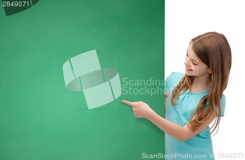 Image of happy little girl with blank blackboard