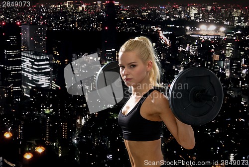 Image of sporty woman exercising with barbell