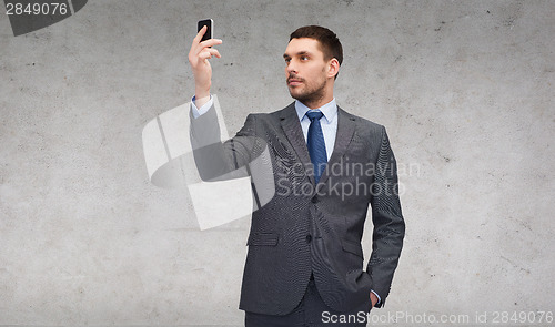 Image of young businessman with smartphone