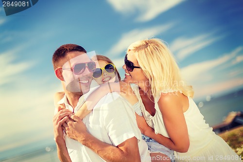 Image of happy family in sunglasses having fun outdoors