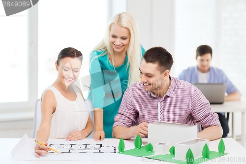 Image of smiling architects working in office