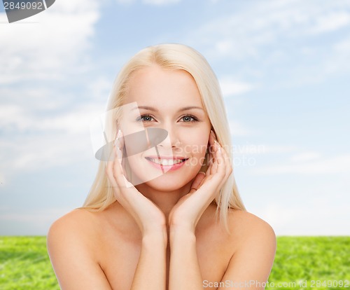 Image of beautiful woman touching her face skin