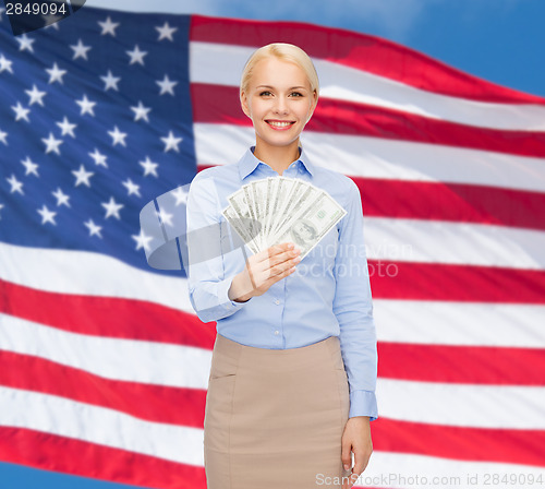 Image of young businesswoman with dollar cash money