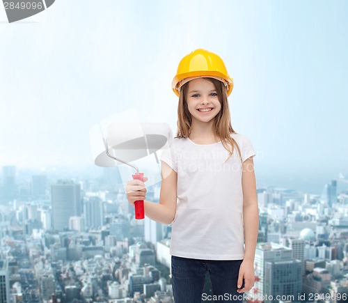 Image of smiling little girl in helmet with paint roller