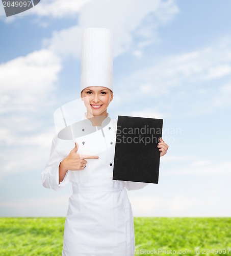 Image of smiling female chef with black blank paper