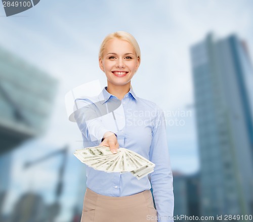 Image of young businesswoman with dollar cash money