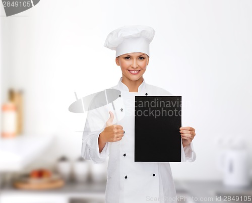 Image of smiling female chef with black blank paper