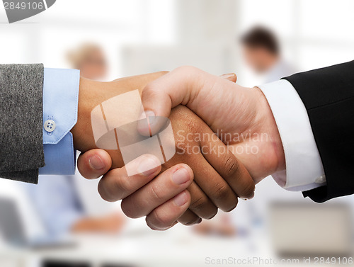 Image of businessman and businesswoman shaking hands