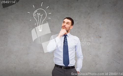 Image of handsome businessman looking up