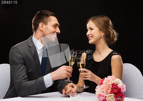 Image of couple with glasses of champagne at restaurant