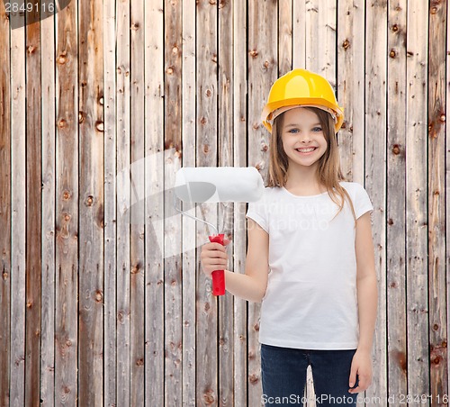 Image of smiling little girl in helmet with paint roller