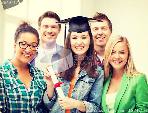 Image of girl in graduation cap with certificate