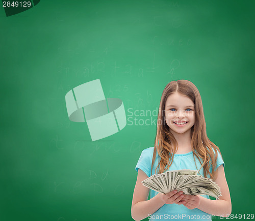 Image of smiling little girl with dollar cash money