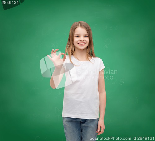 Image of little girl in white t-shirt showing ok gesture
