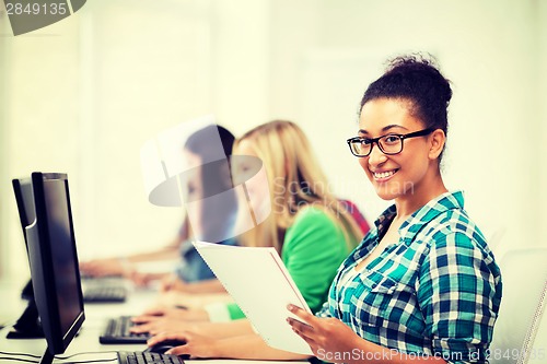 Image of african student with computer studying at school
