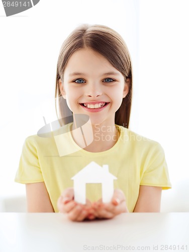 Image of little girl holding white paper house
