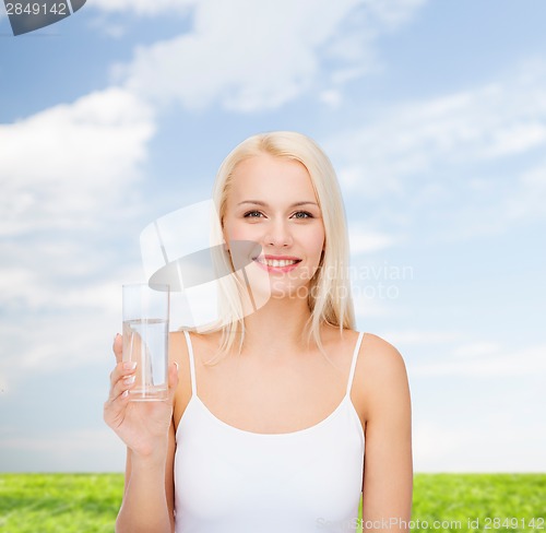 Image of young smiling woman with glass of water