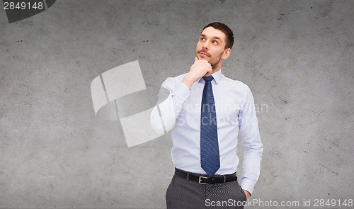 Image of handsome businessman looking up