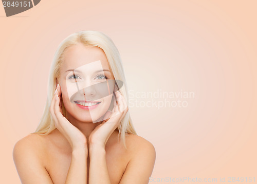 Image of beautiful woman touching her face skin