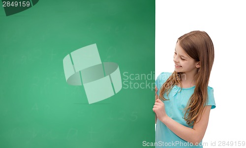 Image of happy little girl with blank blackboard