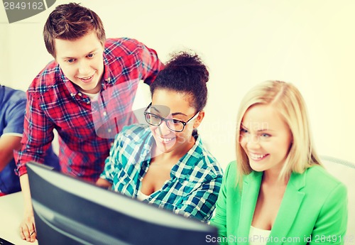 Image of students with computer studying at school